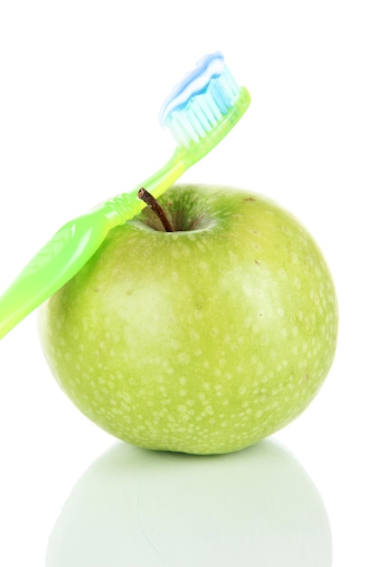 Apple with a toothbrush isolated on white