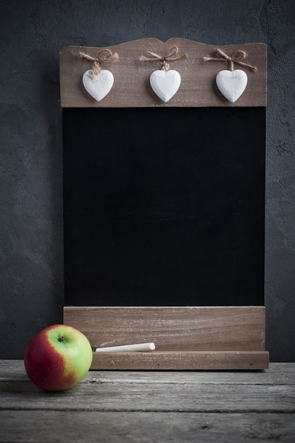 Apple and wooden blackboard