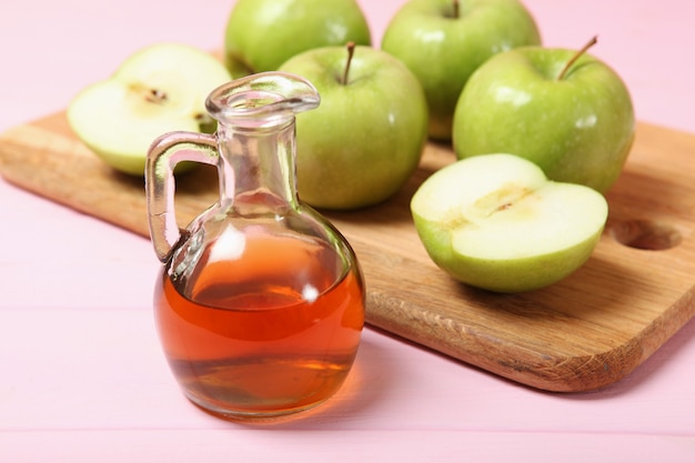 Apples and apple cider vinegar on the table