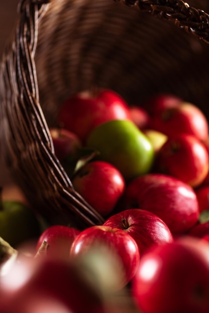 Apples are spilling out of the basket