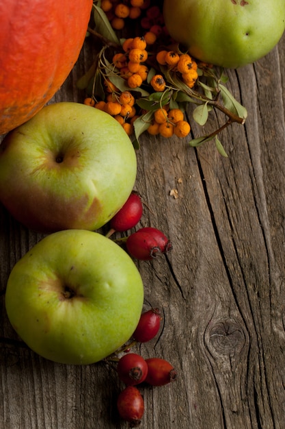 apples and berries on wooden table, top view