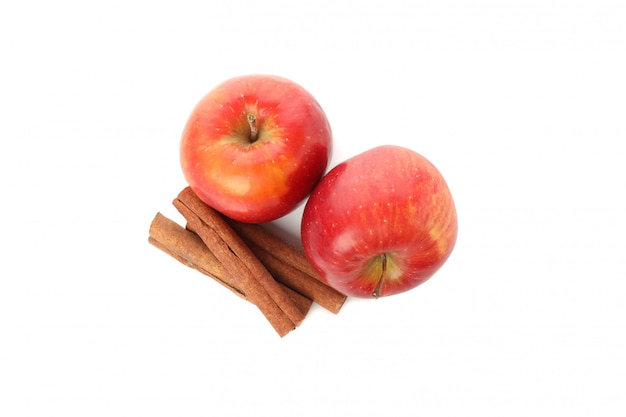 Apples and cinnamon isolated on white.