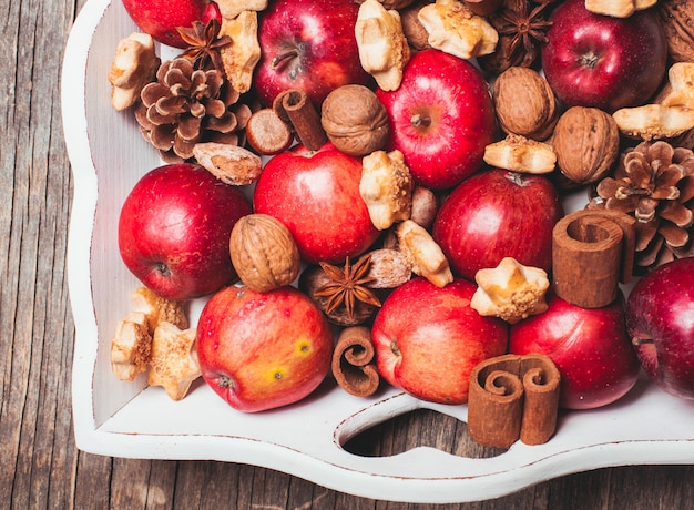 Apples, cones, nuts and cookies with spices. Aroma Christmas