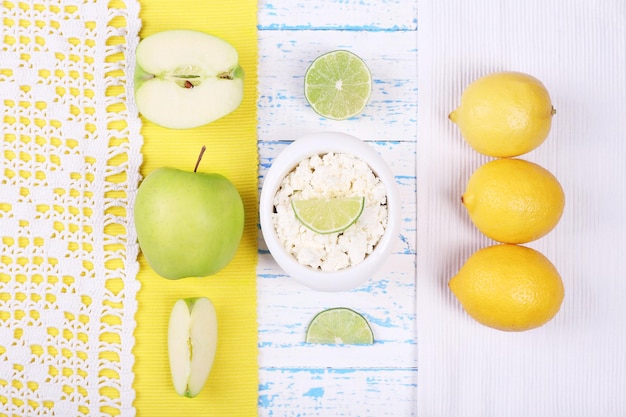 Apples cottage cheese and lemons on wooden table top view