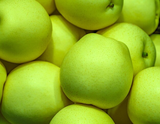 Apples green in bulk on supermarket selective focus