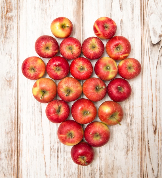 Apples heart over rustic wooden background. Love concept. Vibrant colors