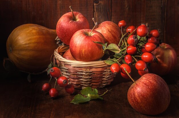 apples and other fruits on a dark wooden background in a rustic style