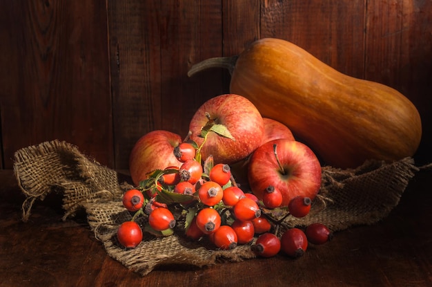 apples and other fruits on a dark wooden background in a rustic style
