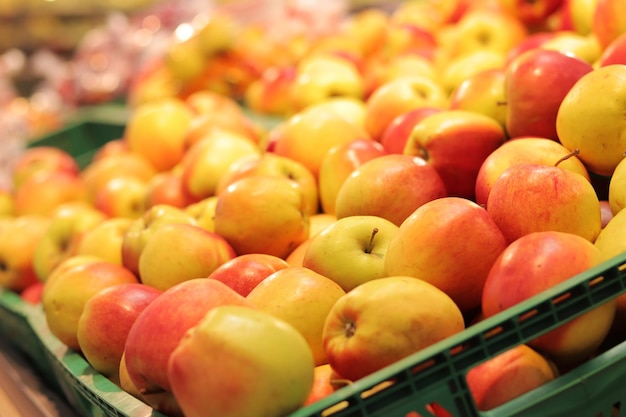 Apples in plastic boxes in a store closeup Ripe apples on sale side view Sale of fruits