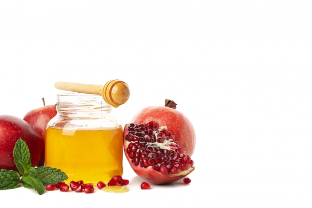 Apples, pomegranate and honey isolated on white. Natural treatment