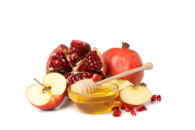 Apples, pomegranate and honey isolated on white.