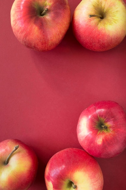 Apples on red background