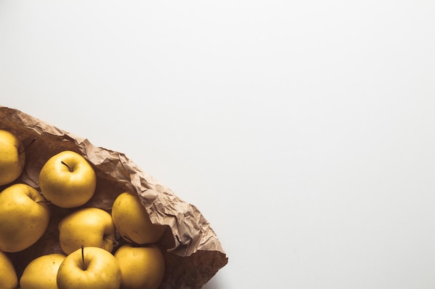 Apples in shopping paper bag on white background