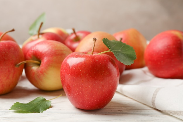 Apples and towel on white wooden table