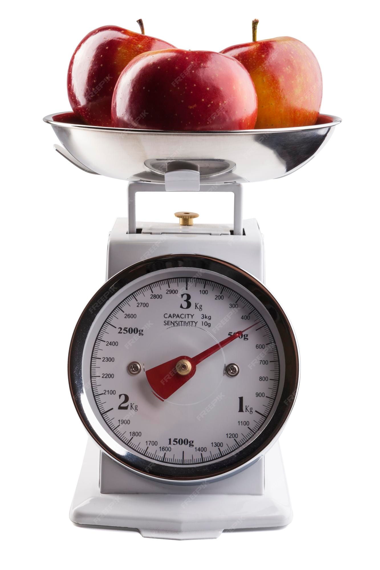 Kitchen scale weighting apples, Stock image