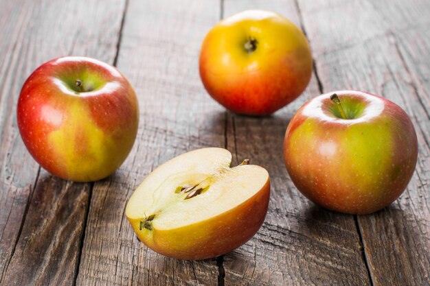 Apples with cinnamon on wooden table