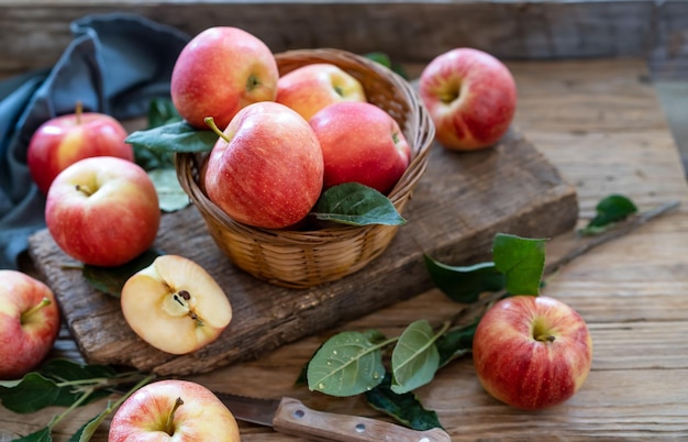 Apples with leaves on the wooden table