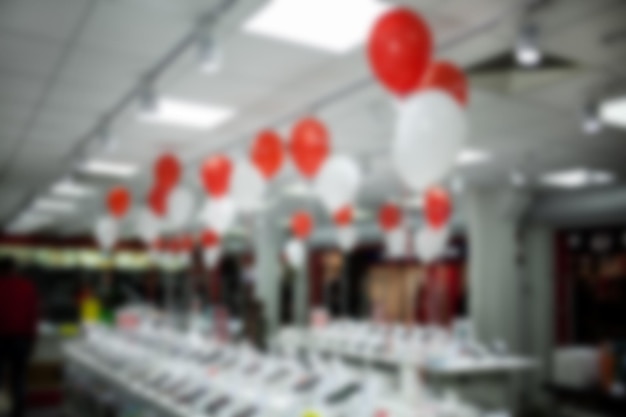 appliance store decorated with red and white balloons blurred image