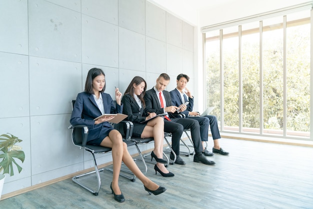 The applicant is sitting to prepare for an interview for a job in office