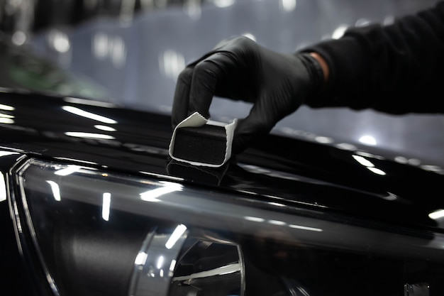 Photo applying nanoceramics to cars. car paint protection concept