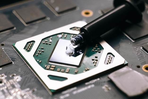 Photo applying thermal paste on the computer's central processing unit computer repair