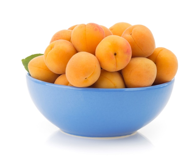 Apricot in bowl isolated on white 