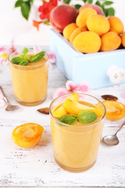 Apricot dessert in glasses on table closeup