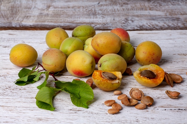 Apricot fruit. Fresh organic apricots on a white wooden background