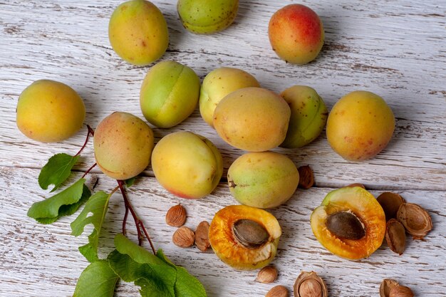 Apricot fruit. Fresh organic apricots on a white wooden table. Vega food.