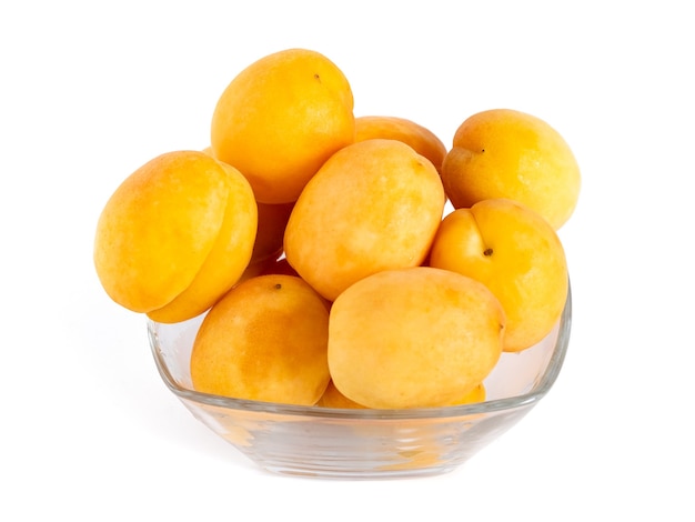 Apricot fruits in the glass bowl isolated on white, healthy food