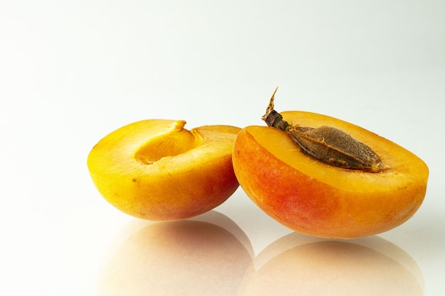 Apricot fruits and half Isolated on white background