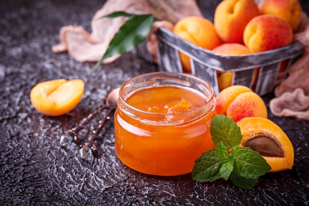 Photo apricot jam in glass jar. selective focus