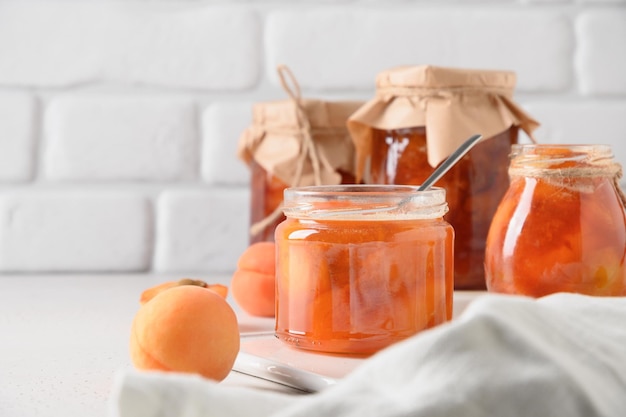 Apricot jam in glass jar with fruits Summer harvest and canned food