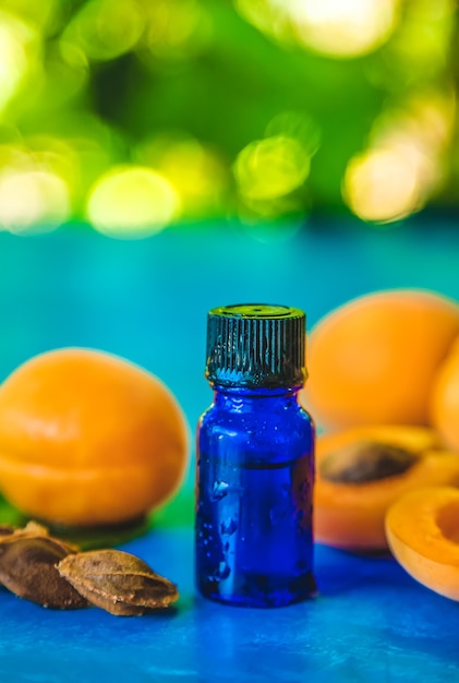 Apricot kernel oil in a bottle. Selective focus.