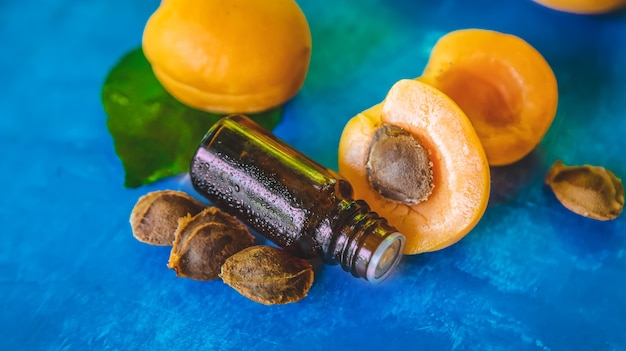 Apricot kernel oil in a bottle. Selective focus.