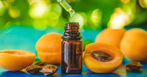 Apricot kernel oil in a bottle. Selective focus.