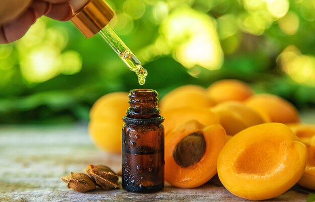 Apricot kernel oil in a bottle. Selective focus.