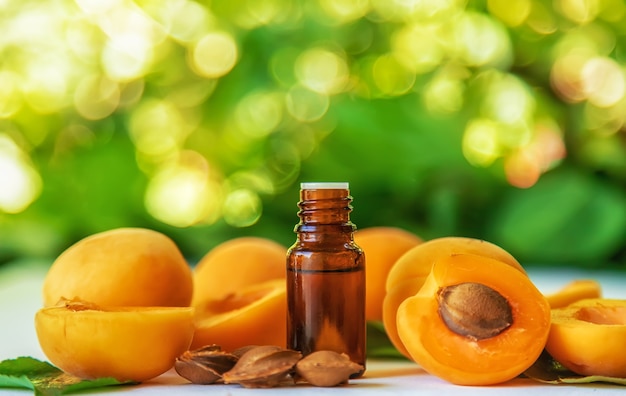 Apricot kernel oil in a bottle. Selective focus.