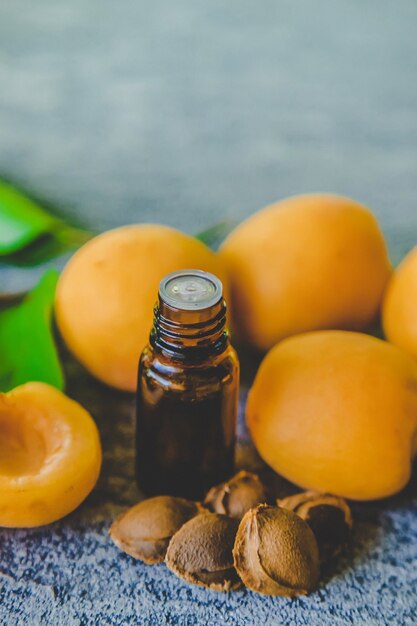 Photo apricot kernel oil in a small bottle. selective focus. nature.