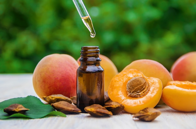 Apricot oil in a small jar. selective focus.