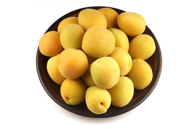 Apricot in a plate white surface