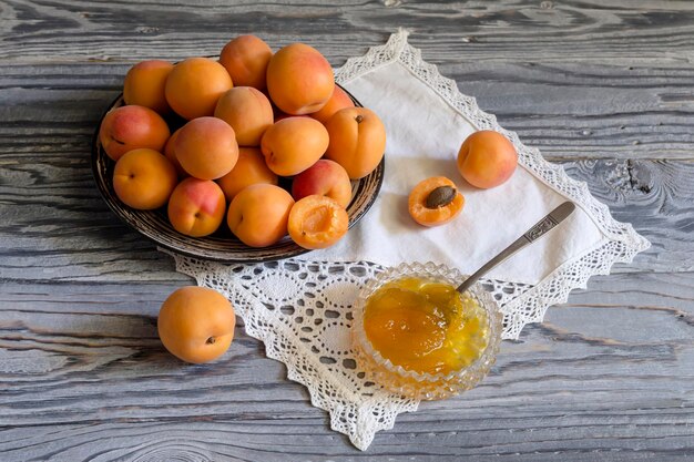 Apricots and apricot jam on a wooden table