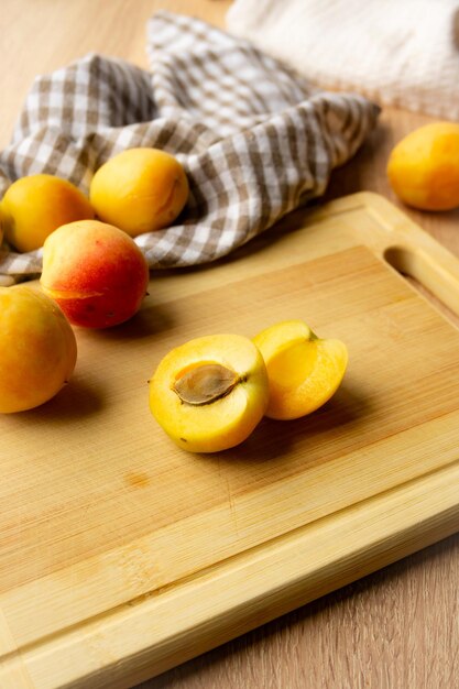 Apricots lying on a wooden board freshness harvesting autumn mood beautiful decoration with a kitchen towel