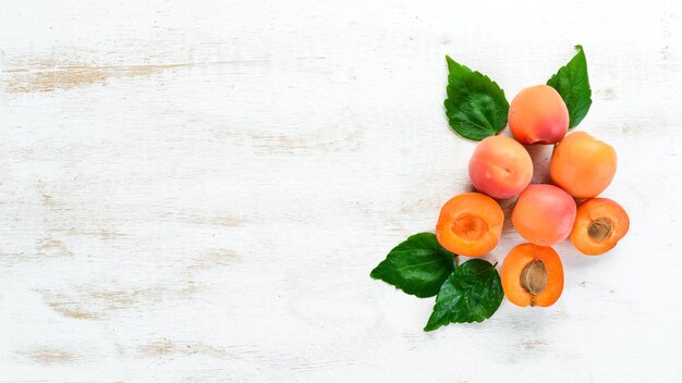 Apricots on a white wooden background Rustic style Top view Free space for your text