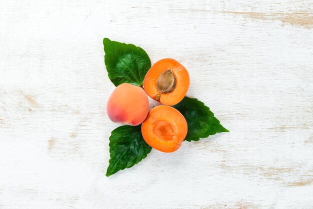 Apricots on a white wooden background Rustic style Top view Free space for your text