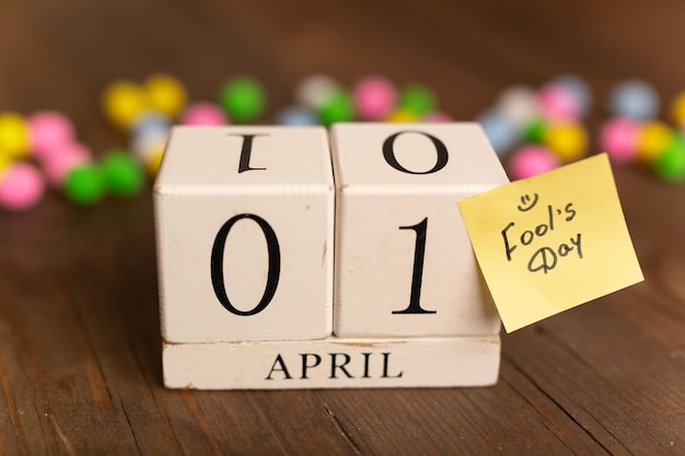 April 1st Image of april 1 wooden calendar with colorful decor on wooden background April Fool's Day
