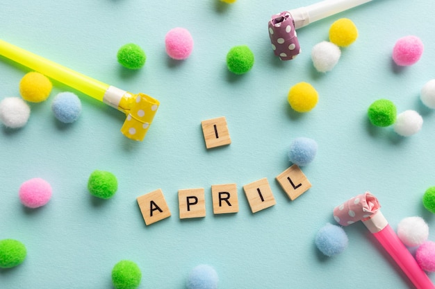 April 1st Image of text April 1 and festive decor on the blue background April Fool's Day