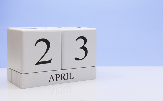 Photo april 23st. day 23 of month, daily calendar on white table with reflection