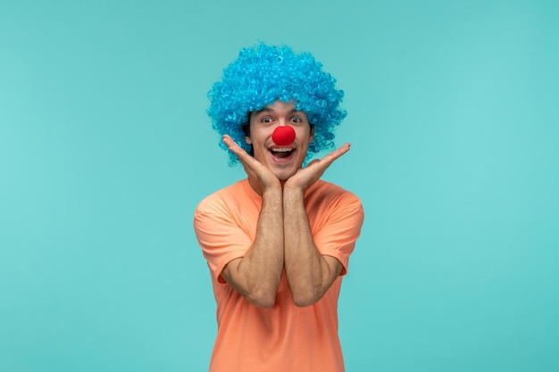 April fools day guy clown happy hands under chin blue hair excited funny red nose