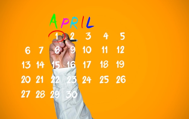 Photo april fools day hand traces 1 number on the calendar